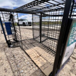 A shopping cart lay on its side near Lohman Avenue on the same day the Las Cruces City Council enacted an ordinance aimed at cracking down on shopping cart use by unhoused people. A cardboard sign in the cart included the words “Homeless,” “hungry” and “God bless,” in addition to a drawing of three crosses. (Photo by Heath Haussamen)