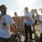 Community organizer Allex Luna leading a chant during a protest at the U.S. Border Patrol station in Las Cruces in May 2017.