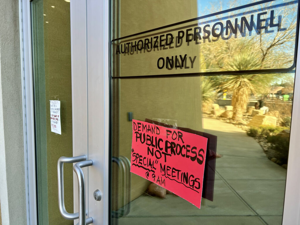 Signs protesting the way the Las Cruces City Council handled the hiring of its city manager last year greeted councilors and the mayor at their entrance to City Hall before Monday's meeting.