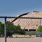 A U.S. Army Stryker is parked on a mesa next to the border wall. It's shown here from the playground at Sunland Park Elementary School, which is just a few hundred yards away.