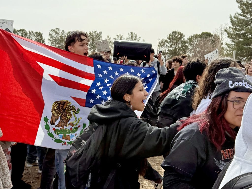 Teens demonstrate outside the fence surrounding Mayfield High School.