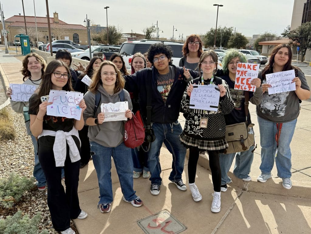 Students from Arrowhead Park Early College High School pose for a photo after getting off a city bus that carried them downtown, where they joined the protest.