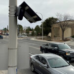 Vehicles pass a police license plate reader on Missouri Avenue in Las Cruces on Tuesday.