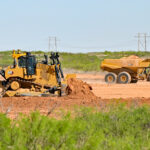 A bulldozer levels earth at the site of one of Project Jupiter's two planned gas-fired power plants.