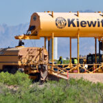 A worker refills a water truck at the construction site for one of two gas-fired power plants Project Jupiter's developers plan to build.